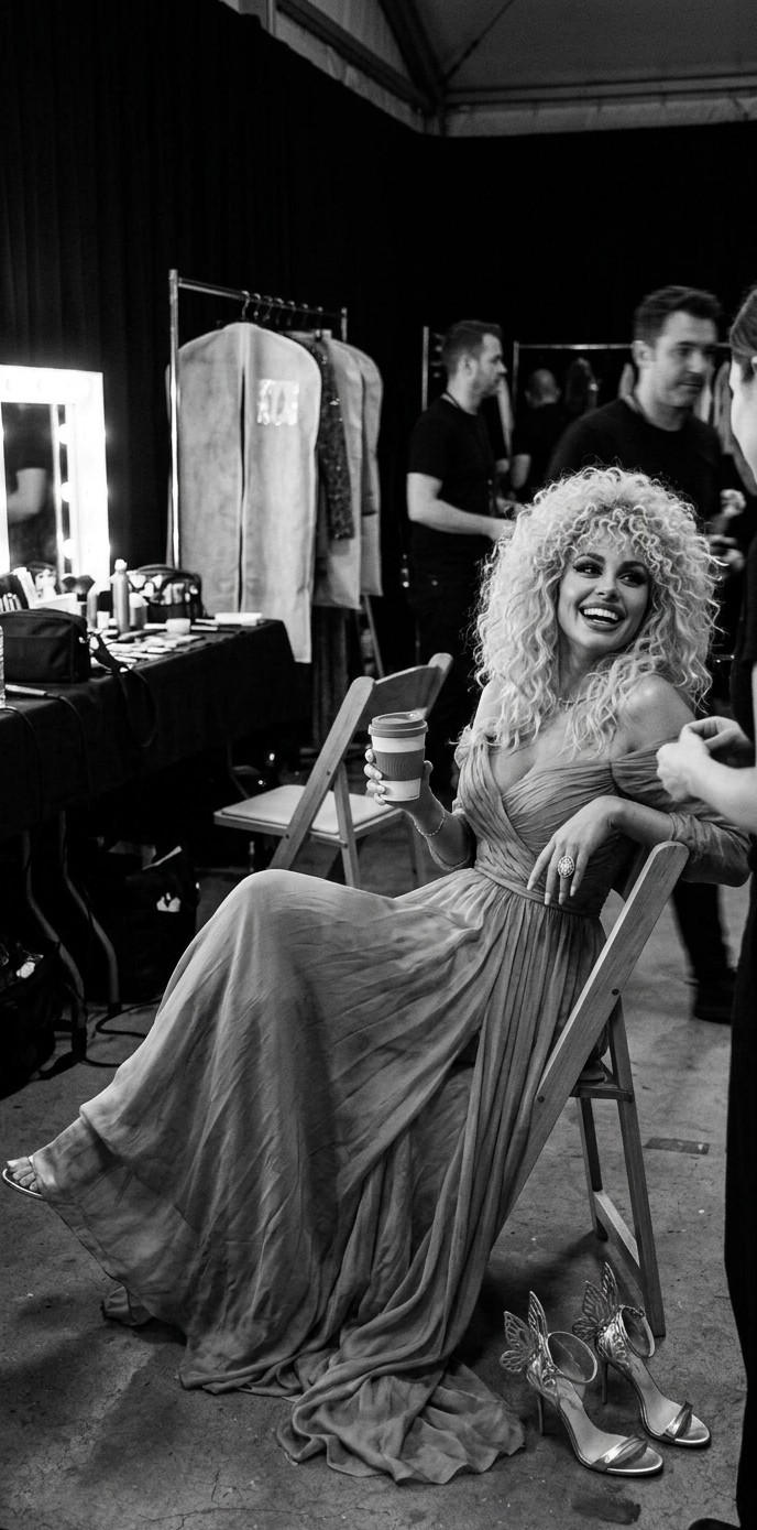 Crystal Liberto seated backstage in a flowing gown